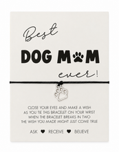 A dog-themed bracelet gift set on a white card. The product includes a black cord bracelet with a silver paw print charm, presented on a card that reads 'Best DOG MOM ever!' with a paw print icon. Dog Mum bracelet. Mother’s Day gift. 
