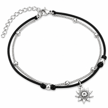 Double black cord and silver chain ankle bracelet. The anklets include black cords with silver beads and a central silver sun charm.