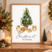 A framed Christmas art print featuring an illustrated decorated tree and wrapped gifts with the text Christmas at The Field House. Personalised Christmas tree print 