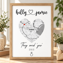 A personalised framed map print featuring a heart-shaped Dublin map with the names 'billy' and 'jamie' at the top and 'They said yes' with a ring icon at the bottom. Engagement print 