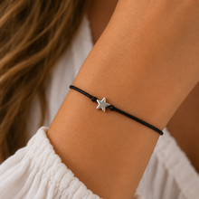 Star wish string bracelet . A black cord bracelet with a small silver star charm. 