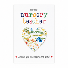Nursery teacher wildflower seeds gift. A white greeting card with the text 'for my nursery teacher' in multicoloured letters above a removable heart shaped seed paper filled with wildflower seeds and 'Thank you for helping me grow!' at the bottom. Plantable Thank you gift for nursery teacher 
