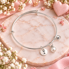 Personalised silver charm bangle with 3 charms - A silver bracelet with a round engraved initial charm and a small pearl bead