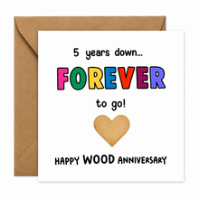 Card for five years married. 5 year anniversary card. Wood anniversary. A square greeting card with a kraft brown envelope behind it. The card reads '5 years down.