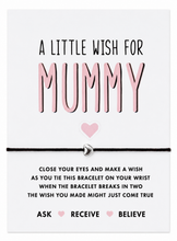 A bracelet gift set with the words 'A LITTLE WISH FOR MUMMY' in black and pink lettering, a small pink heart, and instructions below a black cotton cord bracelet with a silver heart charm.