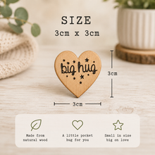 A heart-shaped wooden tag with 'big hug' and small star engravings, shown with size annotations reading 3cm x 3cm on a light wood surface. A size reference panel at the bottom lists material and design details.