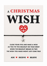 A Christmas Wish bracelet on a white card. The black cotton cord bracelet features a small silver star charm. Secret Santa Gift.