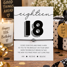 An 18th birthday wish bracelet featuring a white card with black text and a black-and-white striped bead on a blank cotton cord bracelet. 18th wish string bracelet. 