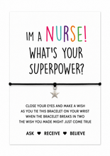 Nurse wish string bracelet. A white display card with colourful text reading 'I'M A NURSE! WHAT'S YOUR SUPERPOWER?' above a black cord bracelet with a small silver star charm. Smaller text below explains a wish activity, and the bottom reads 'ASK RECEIVE BELIEVE'. Nurse gift. Gift for RN.