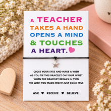 Teacher wish string bracelet. A teacher-themed bracelet card with colourful text and a small silver star charm, displayed on a wooden surface with dried flowers and a pink book in the background.