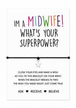 A black cord bracelet with a small silver star charm displayed on a white card that reads 'I'M A MIDWIFE! WHAT'S YOUR SUPERPOWER?' with additional wish string instruction text below. Gift for midwife.