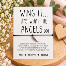 Angel wing wish string bracelet. A white card with black text reading 'WING IT - it’s what the angels do - complete with black cord bracelet with angel wing charm.