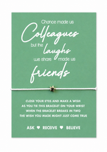 A green card with white text that reads, 'Chance made us Colleagues but the laughs we share made us friends,' tied with a white wish string and a small silver star charm.
