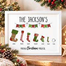 A framed personalised Christmas print with the name 'THE JACKSON'S' at the top, seven colorful Christmas stockings with names underneath, and the phrase 'Making Christmas Magical' at the bottom. Christmas stocking filler / secret Santa gift 