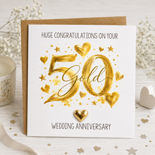 A white and gold 50th wedding anniversary greeting card with gold foil-style lettering and hearts with removable metallic gold heart keepsake.