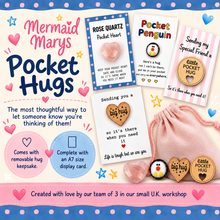 Mermaid Marys Pocket Hugs gift set featuring various printed pocket hug cards, wooden keepsake pucks, and a pink fabric hug pouch on a decorated pastel background.