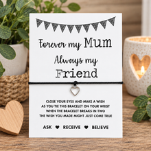 Mum wish string bracelet. A white square card with black printed text reading 'Forever my Mum Always my Friend' and a small silver heart charm tied with a black cord across the centre.