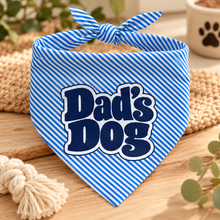 A blue and white striped pet bandana with a tie-neck loop, featuring the text 'Dad's Dog' in dark blue bubble letters with a white outline. Dads dog bandana. Funny slogan dog scarf tie on adjustable.