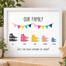 A framed personalised family print featuring colourful high-top sneakers labeled with names under the heading 'OUR FAMILY' and the phrase 'JUST THE RIGHT AMOUNT OF CRAZY!' at the bottom. Customised converse print 