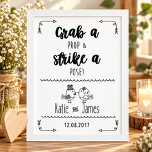 A personalised wedding sign with black text reading 'Grab a prop & strike a pose!' Wedding sign prints 
