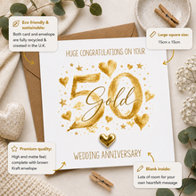 A 50th wedding anniversary greeting card with a metallic gold foil '50' and heart design, shown with a kraft envelope on a styled flat-lay background with text callouts detailing product features.