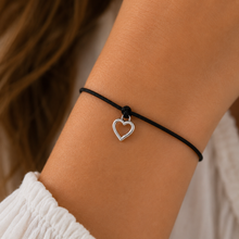 Heart wish bracelet. Black cord bracelet with a silver heart charm.