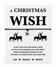 A Christmas-themed bracelet gift card with the words 'A CHRISTMAS WISH' in large black text. The card shows a black cord bracelet with a small silver star charm, flanked by black deer and heart silhouettes.