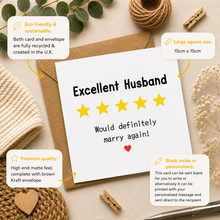 A white husband card review style with the words 'Excellent Husband' and five yellow stars, styled on a kraft envelope with decorative dried flowers, rope, and fabric. Callout boxes around the card describe eco-friendly sustainability, large square size (15cm x 15cm), premium matte finish, and blank inside option.