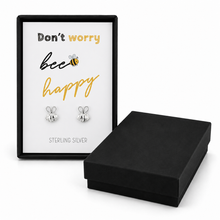 Sterling silver bee stud earrings displayed on a white card inside a black gift box that reads 'Don't worry bee happy' with 'STERLING SILVER'. Don’t worry bee happy bee earrings gift set.