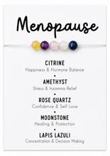 A menopause-themed beaded bracelet displayed on a white card with text listing stone names and benefits: Citrine, Amethyst, Rose Quartz, Moonstone, and Lapis Lazuli.