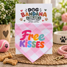 A pink and white checkered dog bandana with the words 'Free Kisses' in colourful lettering. Pink gingham dog neck tie - humour