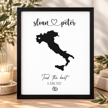 A black-and-white personalised wedding print featuring a black silhouette map of Italy with the names 'sloan & peter' at the top and 'Tied the knot 11 June 2022' below, customised wedding gift 