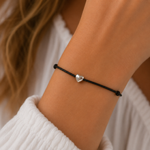 Heart wish bracelet. Small silver heart bead on a black cotton cord bracelet.