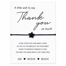 A white card with black text that says 'A little wish to say Thank you so much!' above a black cord bracelet with a black star charm. Smaller text below explains how to use the wish bracelet, and the words 'ASK RECEIVE BELIEVE' appear at the bottom.