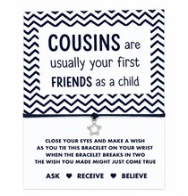 A square card-style bracelet gift with a black and white chevron border and printed message: 'COUSINS are usually your first FRIENDS as a child.' A small silver star charm hangs from the centre. Gift for cousin.
