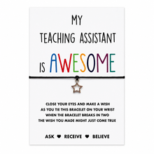 Teaching assistant wish string bracelet. A black cord bracelet with a small silver star charm, presented on a white card that reads 'MY TEACHING ASSISTANT IS AWESOME' with the word 'AWESOME' in rainbow colours. The card also includes wish instructions.
