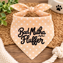 Bad mutha fluffer dog bandana in peach and white polka dot with black text. Funny slogan dog scarf. Adjustable tie on dog bandana. Bad Mother Fluffer.