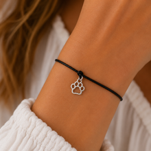 Dog paw wish bracelet. Silver dog paw charm on a black waxed cotton cord bracelet.