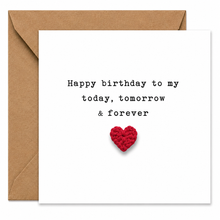 A square white birthday card with black typewriter-style text reading 'Happy birthday to my today, tomorrow & forever' and a small red crocheted heart near the bottom, shown with a brown kraft envelope behind it on a white background.