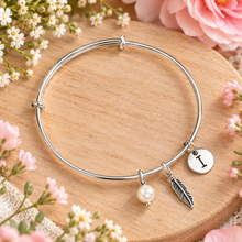Adjustable silver feather bangle with 3 charms 