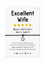 A white rectangular card with black text reading 'Excellent Wife' and 'Would definitely marry again!' with five yellow stars, plus a small silver star charm on a black cord, shown on a white background. Wife bracelet 