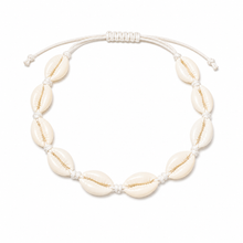 A white cowrie shell beaded anklet with a white adjustable cord slider clasp. Shell ankle bracelet