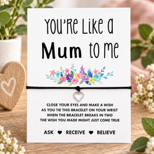 Like a mum to be wish string bracelet. Presentation card with the message 'You're Like a Mum to me' and a colourful floral illustration, tied with a black cord bracelet and a small heart-shaped charm. Gift for step mum 