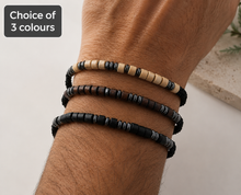 Adjustable Morse code bracelet for him. The bracelets feature black beads, light beige wood beads, and gray metallic beads.