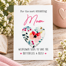 Plantable seed paper gift for mum. A white greeting card with the words 'the most amazing MUM' with a removable floral seed paper heart in the centre. Birthday gift for Mum. Mother’s Day gift 