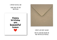 Birthday card with 'Happy birthday you beautiful human' text and a heart, next to a kraft envelope on a white background.