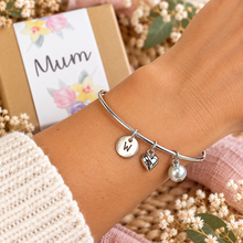 Personalised Silver charm bangle for mum. Perfect for a birthday or Mother’s Day gift for Mum. Simple silver bangle complete with 3 charms.