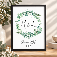 A personalised print with a green eucalyptus wreath and the names 'M & L', plus the text 'She said YES' and the date '18.01.21. Engagement print with initials 